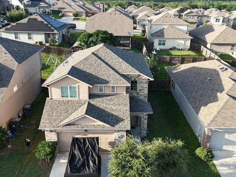 Aerial view of a two-story home and its neighborhood